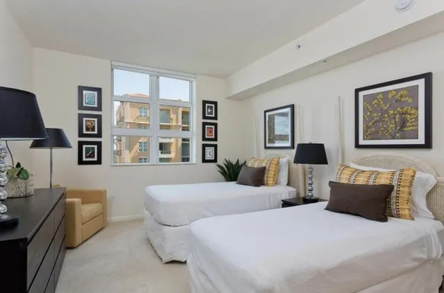 a bedroom with two beds and a couch