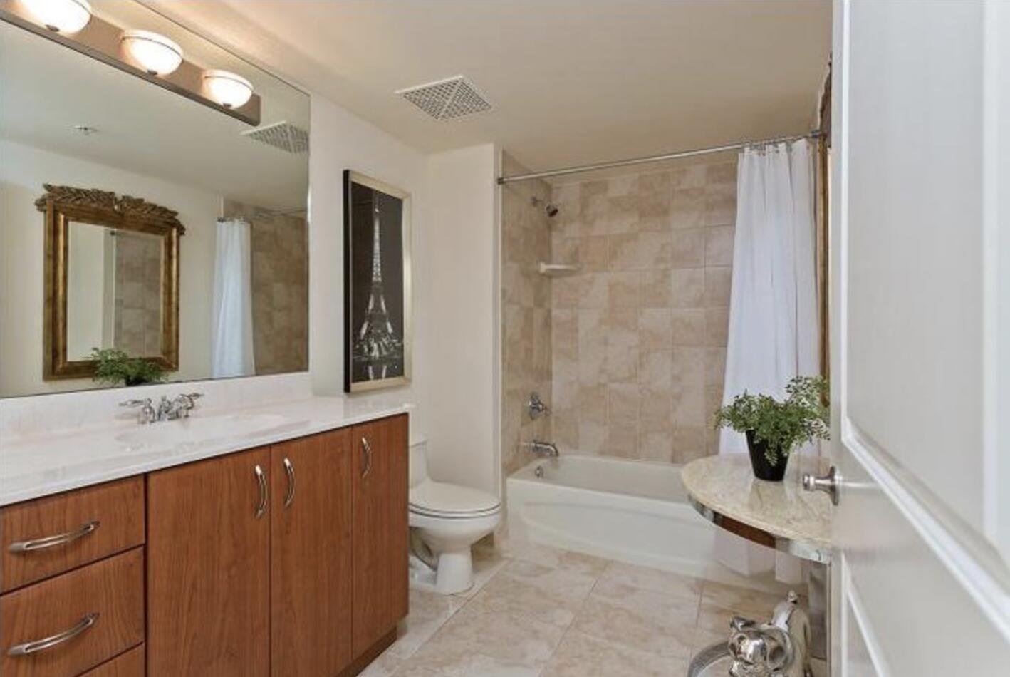 403 South Sapodilla Avenue, Unit 618 West Palm Beach, FL 33401 - Photo 12 of 20 a bathroom with a granite countertop sink a toilet and shower