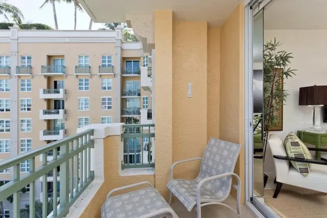 a view of a balcony with furniture and a potted plant