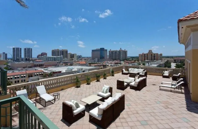 a terrace with outdoor seating and city view