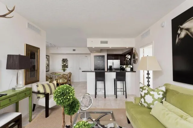 a living room with furniture a chandelier and a flat screen tv