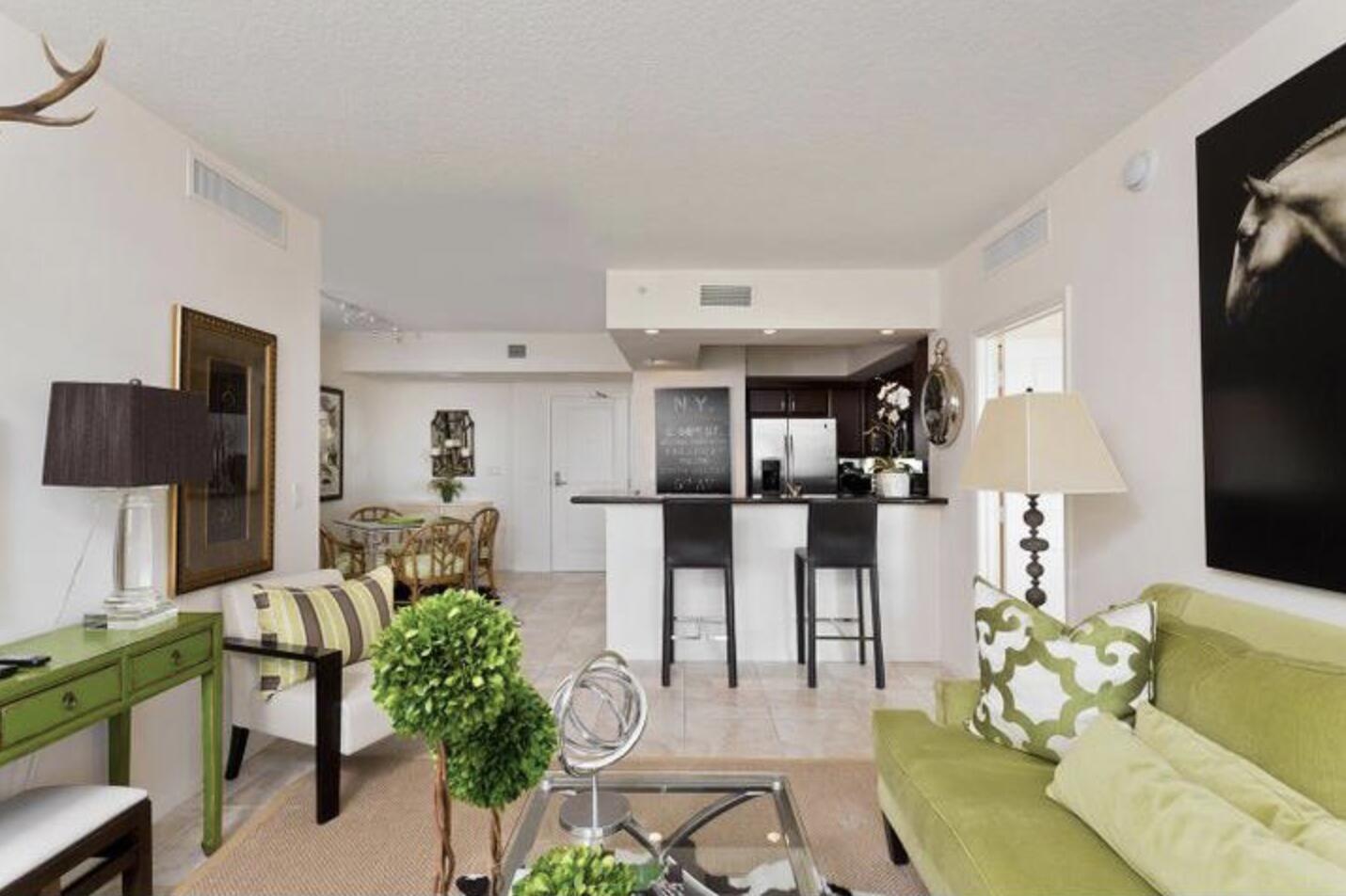 403 South Sapodilla Avenue, Unit 618 West Palm Beach, FL 33401 - Photo 3 of 20 a living room with furniture a chandelier and a flat screen tv