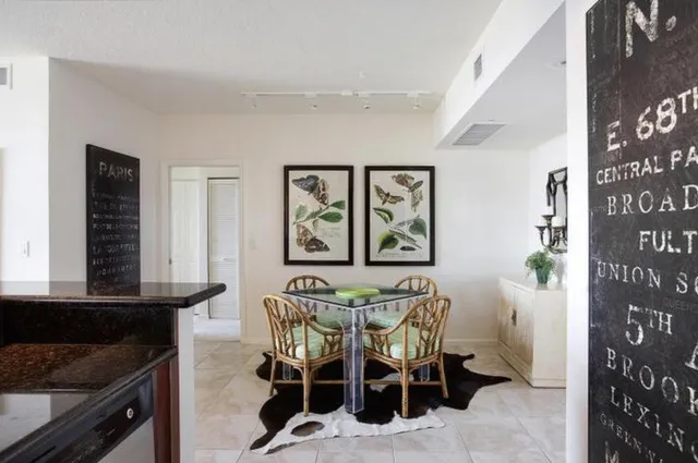 a view of a dining room with furniture and front door