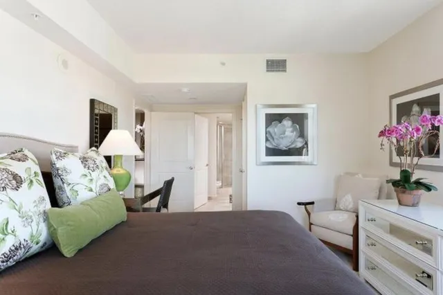 a living room with furniture and flowers