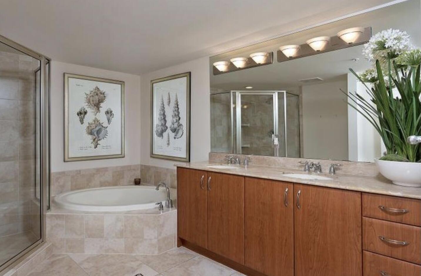 403 South Sapodilla Avenue, Unit 618 West Palm Beach, FL 33401 - Photo 10 of 20 a bathroom with a granite countertop sink a large mirror and a bathtub