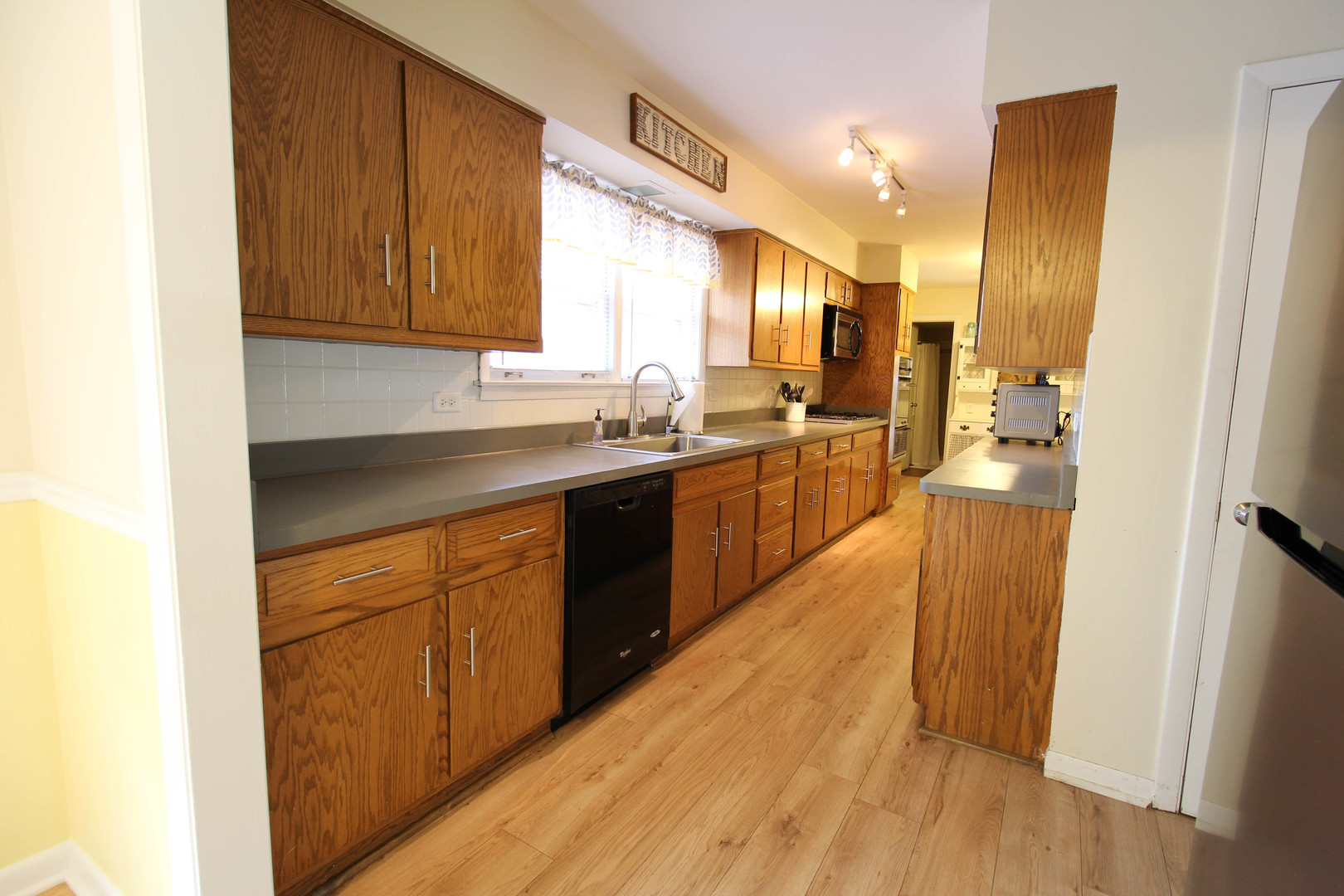 10-s021 Plainfield-Naperville Road Naperville, IL 60565 - Photo 17 of 40 a kitchen with stainless steel appliances granite countertop wooden cabinets a sink and dishwasher