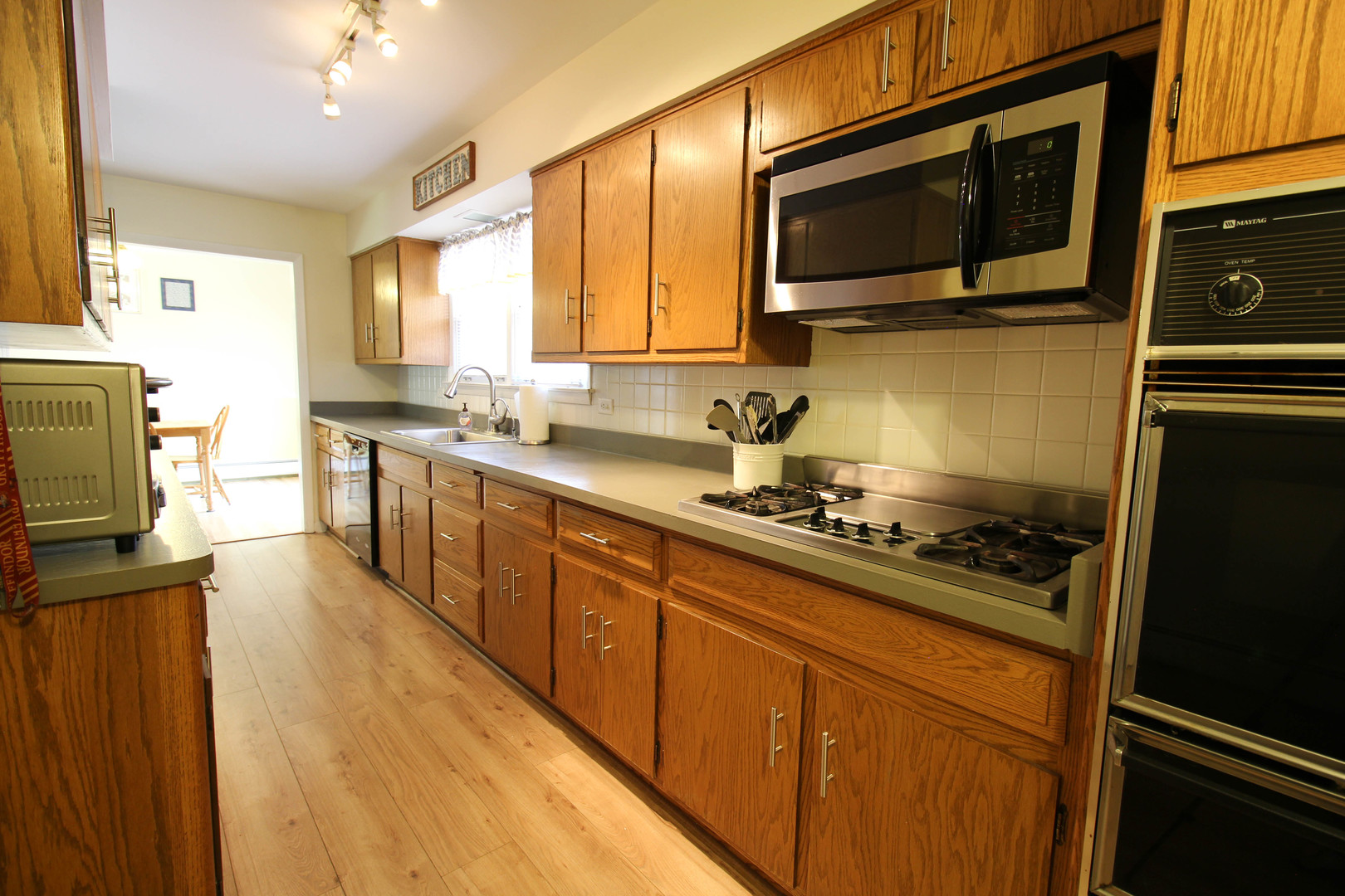 10-s021 Plainfield-Naperville Road Naperville, IL 60565 - Photo 19 of 40 a kitchen with stainless steel appliances a stove microwave and sink