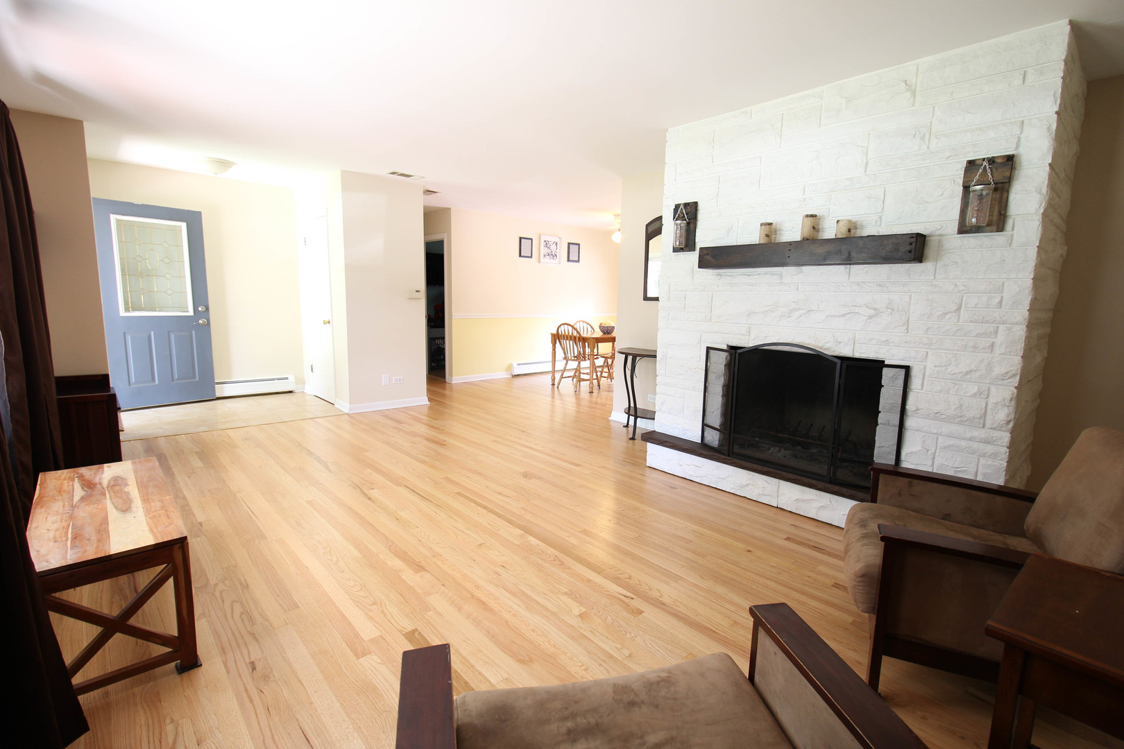 10-s021 Plainfield-Naperville Road Naperville, IL 60565 - Photo 6 of 40 a view of empty room with fireplace and wooden floor