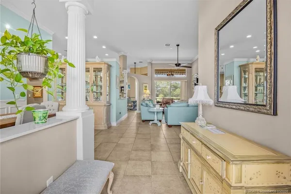 a living room with furniture a flat screen tv and a large window