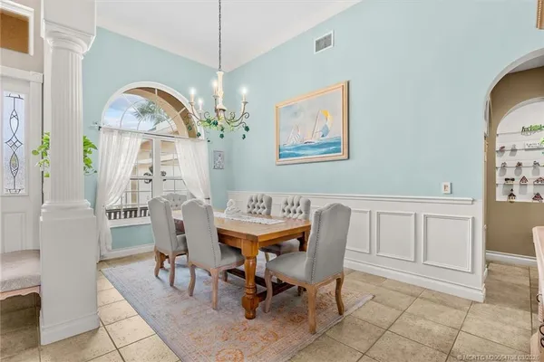 a living room with furniture and a painting on the wall