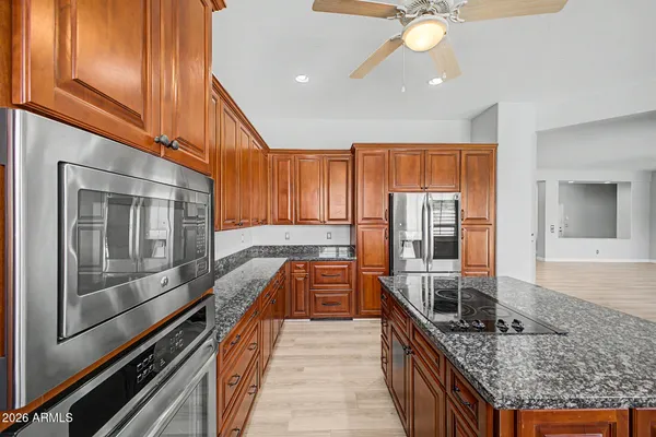 a kitchen with stainless steel appliances granite countertop a sink and stove