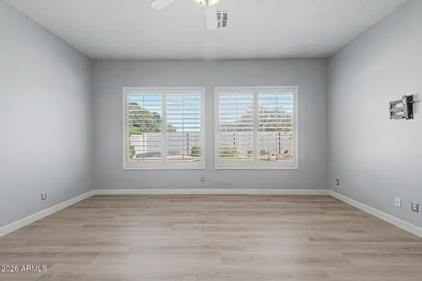 wooden floor in an empty room with a window