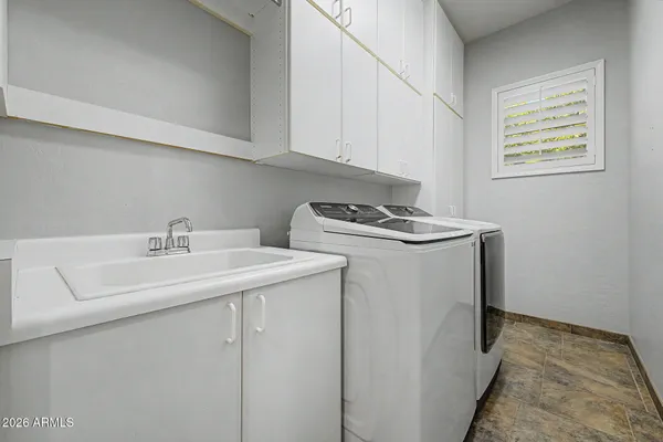 a utility room with sink washer and dryer