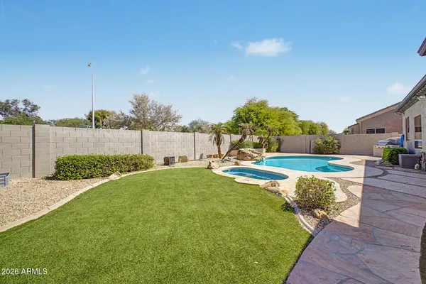 a view of a swimming pool with a lounge chair