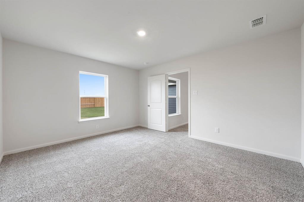 1307 Reed Street Greenville, TX 75401 - Photo 4 of 5 an empty room with windows