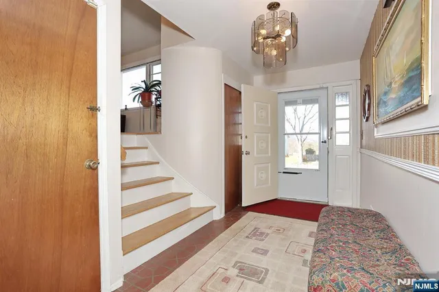 a living room with furniture flowerpot and wooden floor