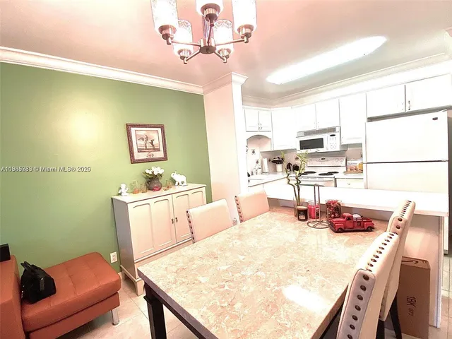 a view of a dining room with furniture and a kitchen