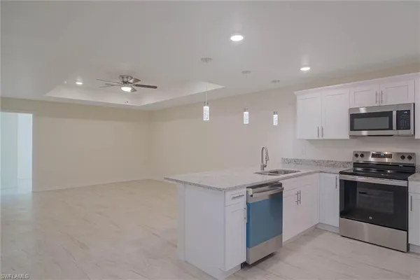 a kitchen with a sink stove and microwave