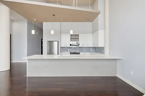 a view of kitchen with cabinets and wooden floor