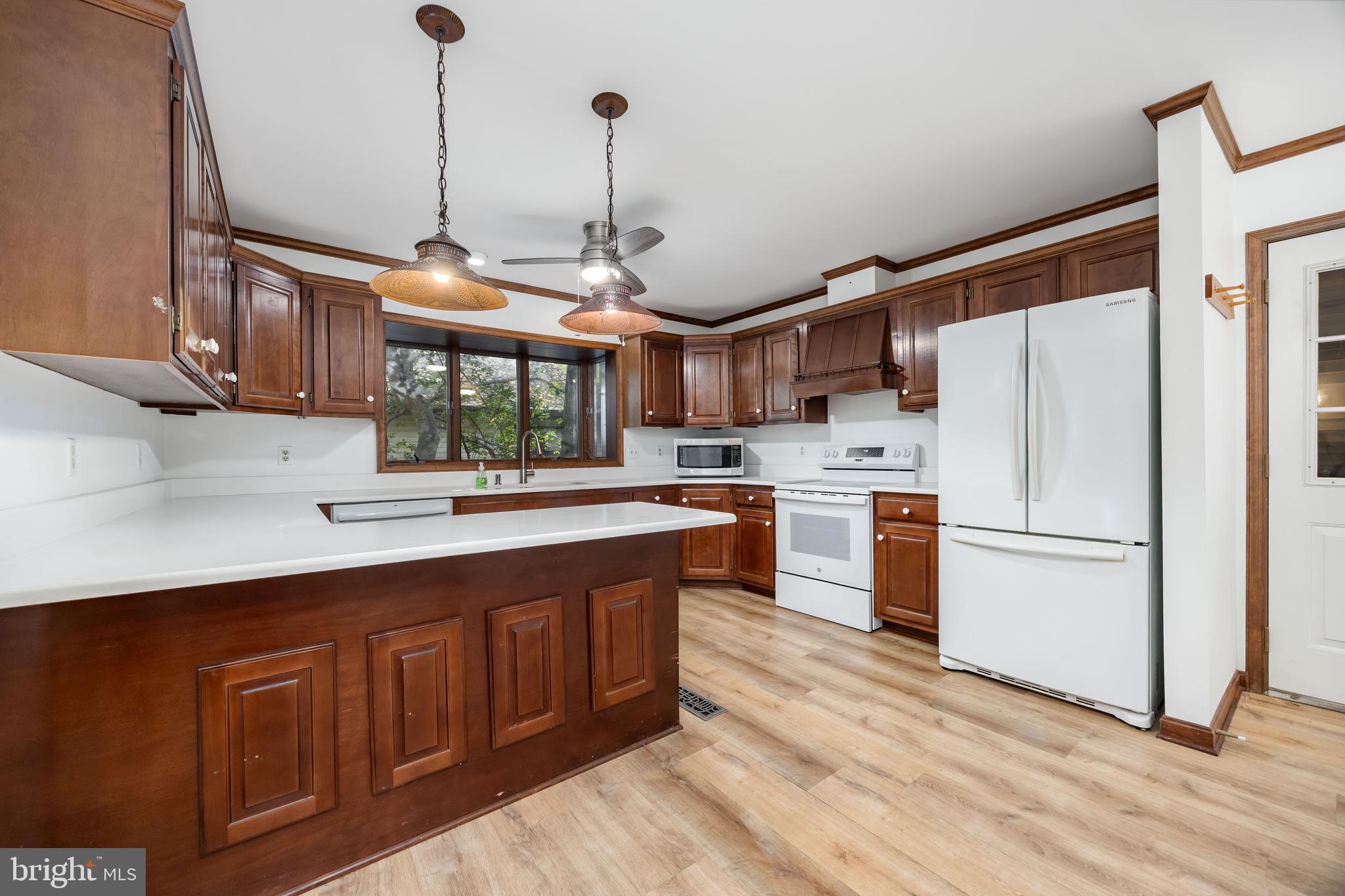 19 Brookside Road Ocean Pines, MD 21811 - Photo 13 of 80 a kitchen with stainless steel appliances granite countertop a sink a stove a refrigerator and island with wooden floor