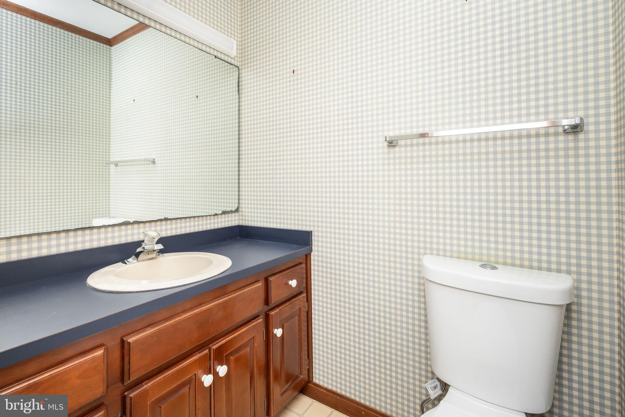 19 Brookside Road Ocean Pines, MD 21811 - Photo 21 of 80 a bathroom with a granite countertop toilet sink and mirror