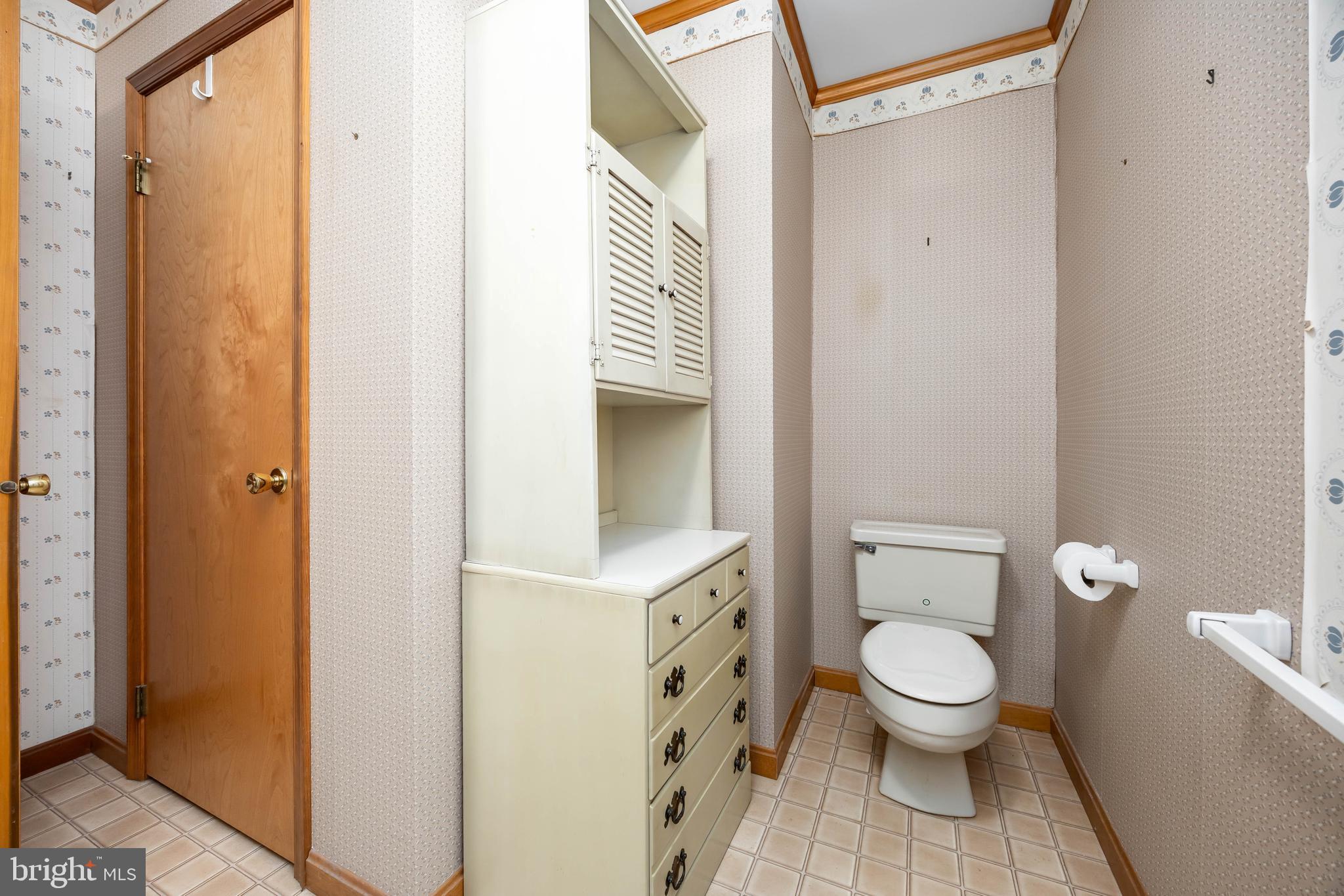 19 Brookside Road Ocean Pines, MD 21811 - Photo 43 of 80 a white toilet sitting next to a bathroom sink