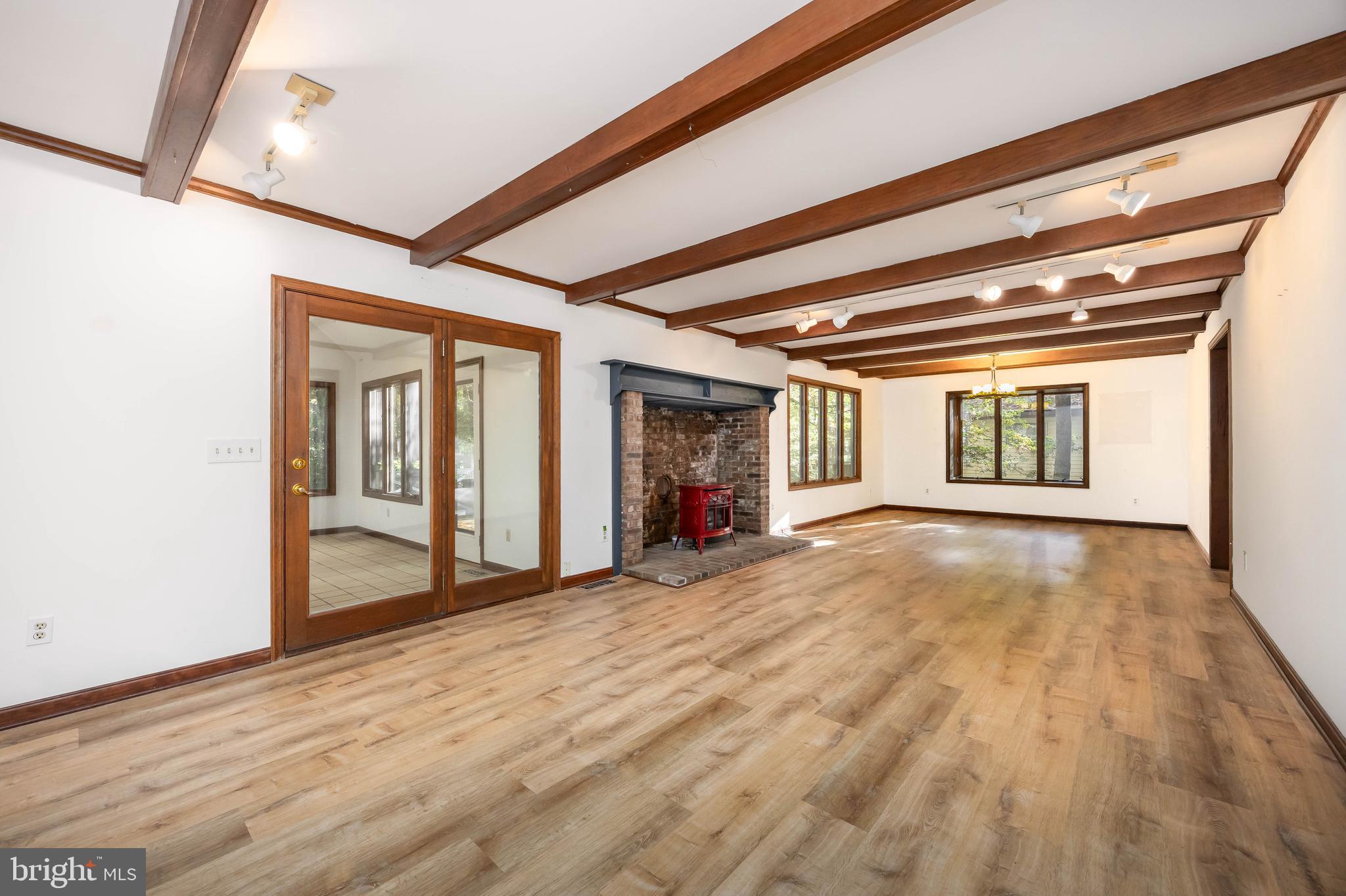 19 Brookside Road Ocean Pines, MD 21811 - Photo 6 of 80 a view of an empty room with wooden floor and a window