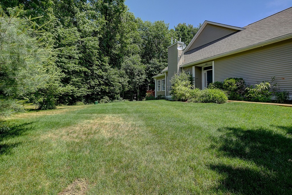 4 Old Stage Road, Unit 4 Litchfield, NH 03052 - Photo 2 of 30 a view of a house with yard and green space