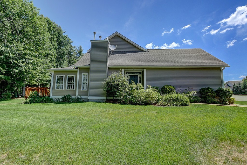 4 Old Stage Road, Unit 4 Litchfield, NH 03052 - Photo 3 of 30 a front view of a house with a garden