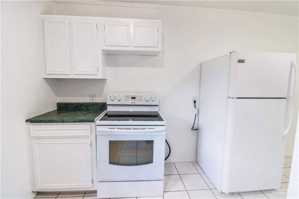 2612 West 17 1/2 Street, Unit 9 McAllen, TX 78504 - Photo 5 of 13 a kitchen with a stove top oven and cabinets