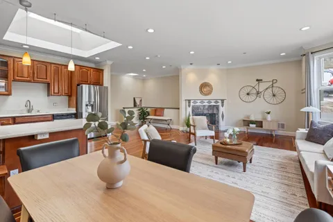 a living room with fireplace furniture and a wooden floor