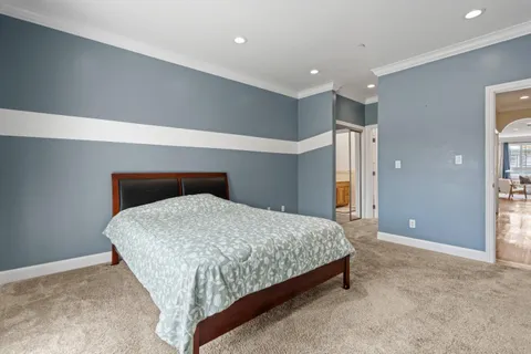 a bathroom with a granite countertop sink a toilet and a mirror