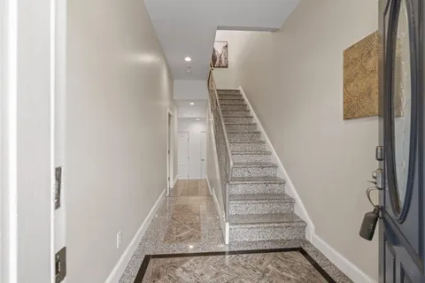a living room with fireplace furniture wooden floor and a large window