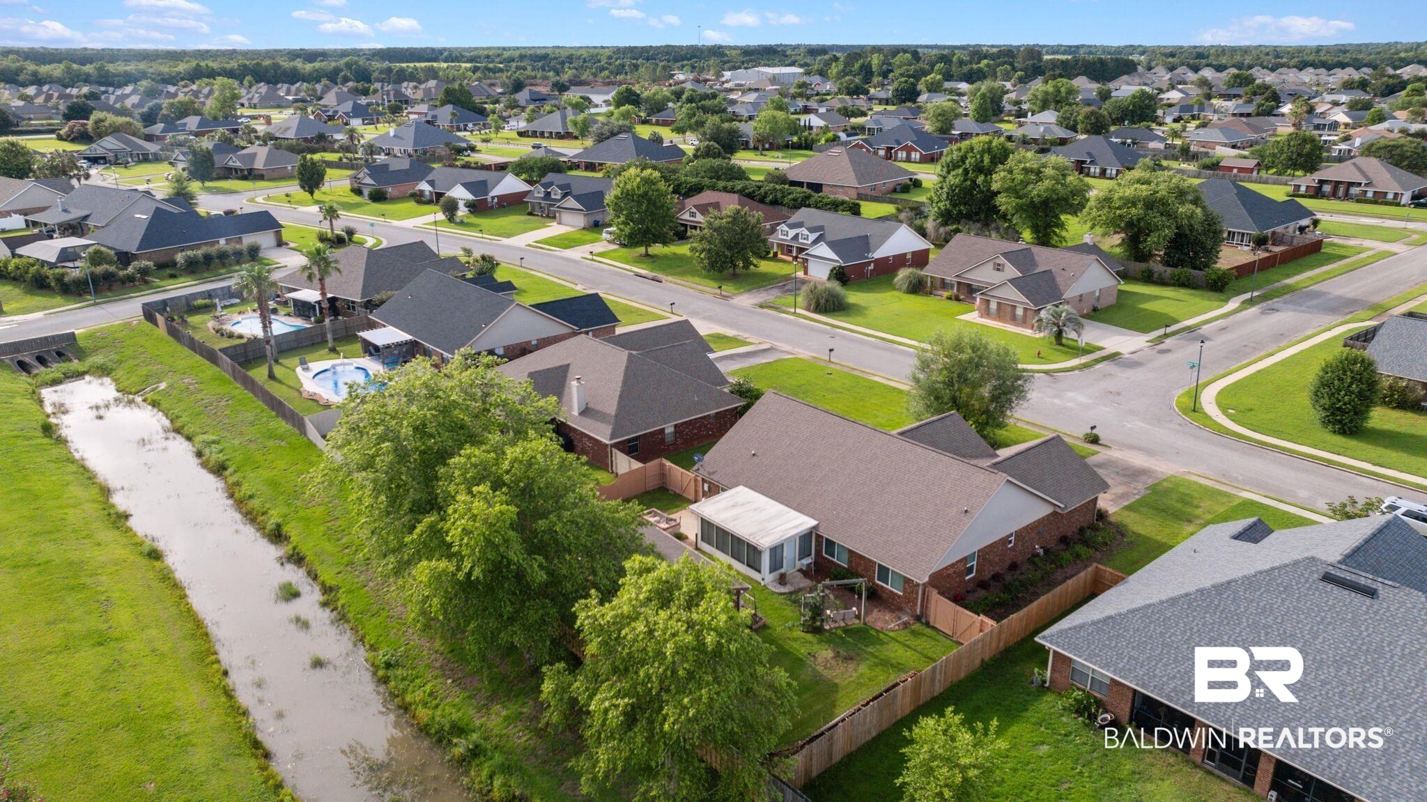 562 Vestige Mews Foley, AL 36535 - Photo 49 of 54 Aerial perspective of a residential neighborhood with a variety of single-story homes featuring shingled roofs and brick exteriors