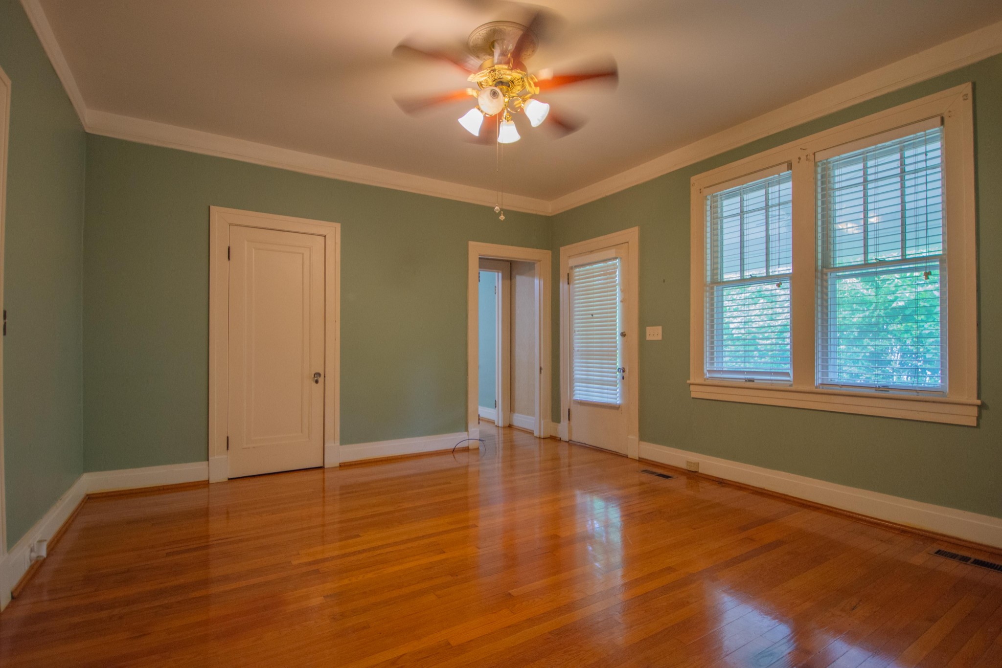 311 South 3rd Street Pulaski, TN 38478 - Photo 19 of 44 a view of an empty room with window and wooden floor
