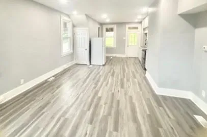 a view of a room with wooden floor and window