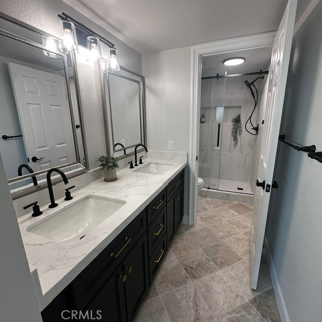 34112 Selva Road, Unit 336 Dana Point, CA 92629 - Photo 11 of 18 a bathroom with double vanity and a mirror