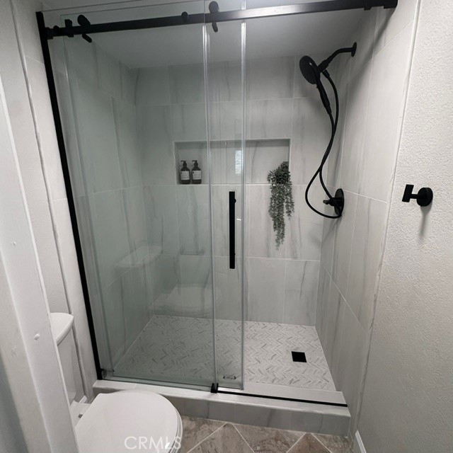 34112 Selva Road, Unit 336 Dana Point, CA 92629 - Photo 12 of 18 a bathroom with a shower and toilet