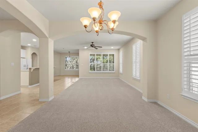 an empty room with windows and cabinet