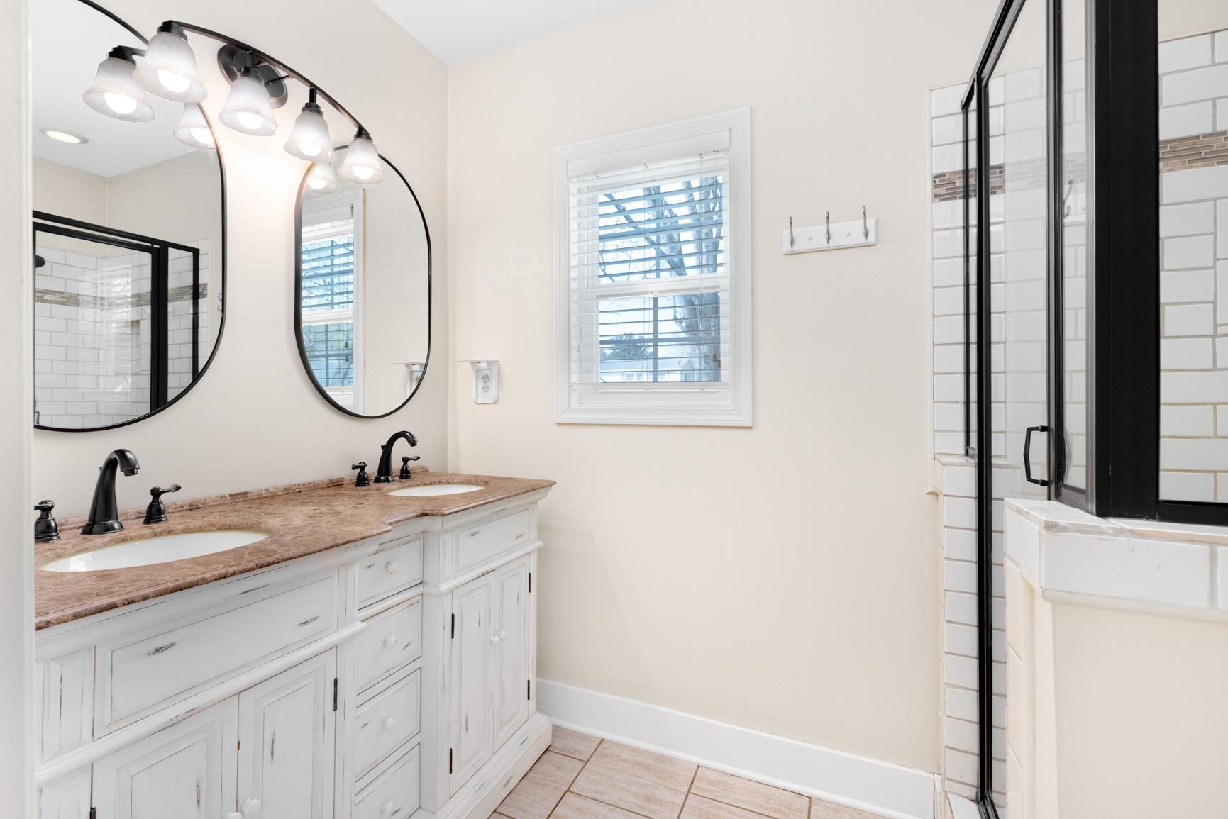 331 Alexander Street Memphis, TN 38111 - Photo 17 of 25 Bathroom with a shower stall, double vanity, healthy amount of natural light, and light tile patterned floors