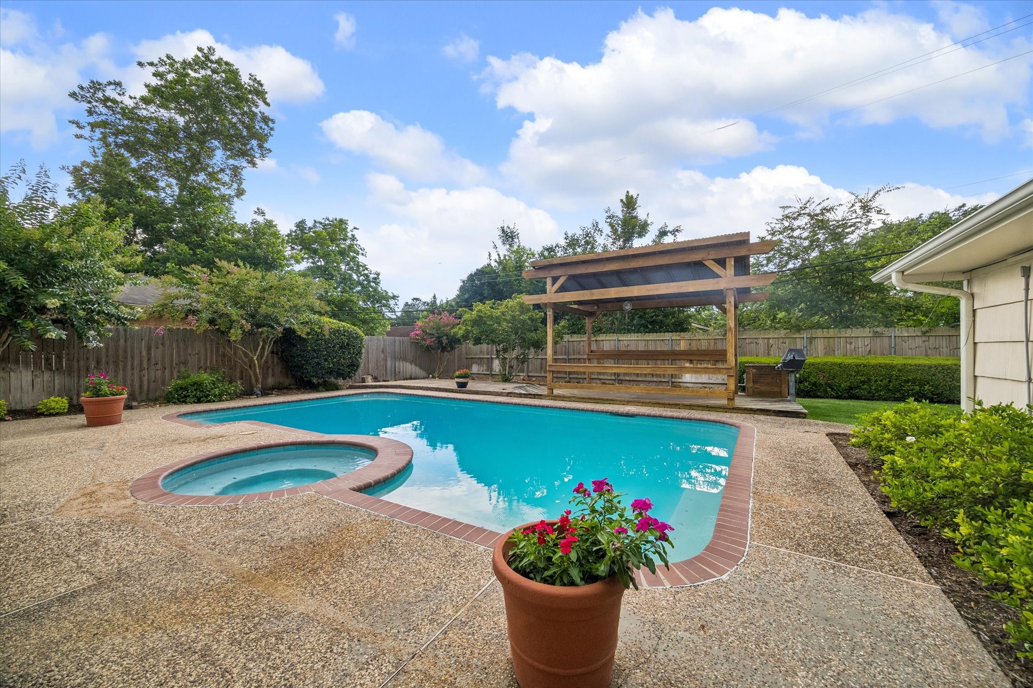5515 Sylmar Road Houston, TX 77081 - Photo 25 of 28 View of the back deck shows the pool & hot tub area., Notice the covered picnic area with a gas grill , certain to be crowd pleaser at your back yard gatherings .