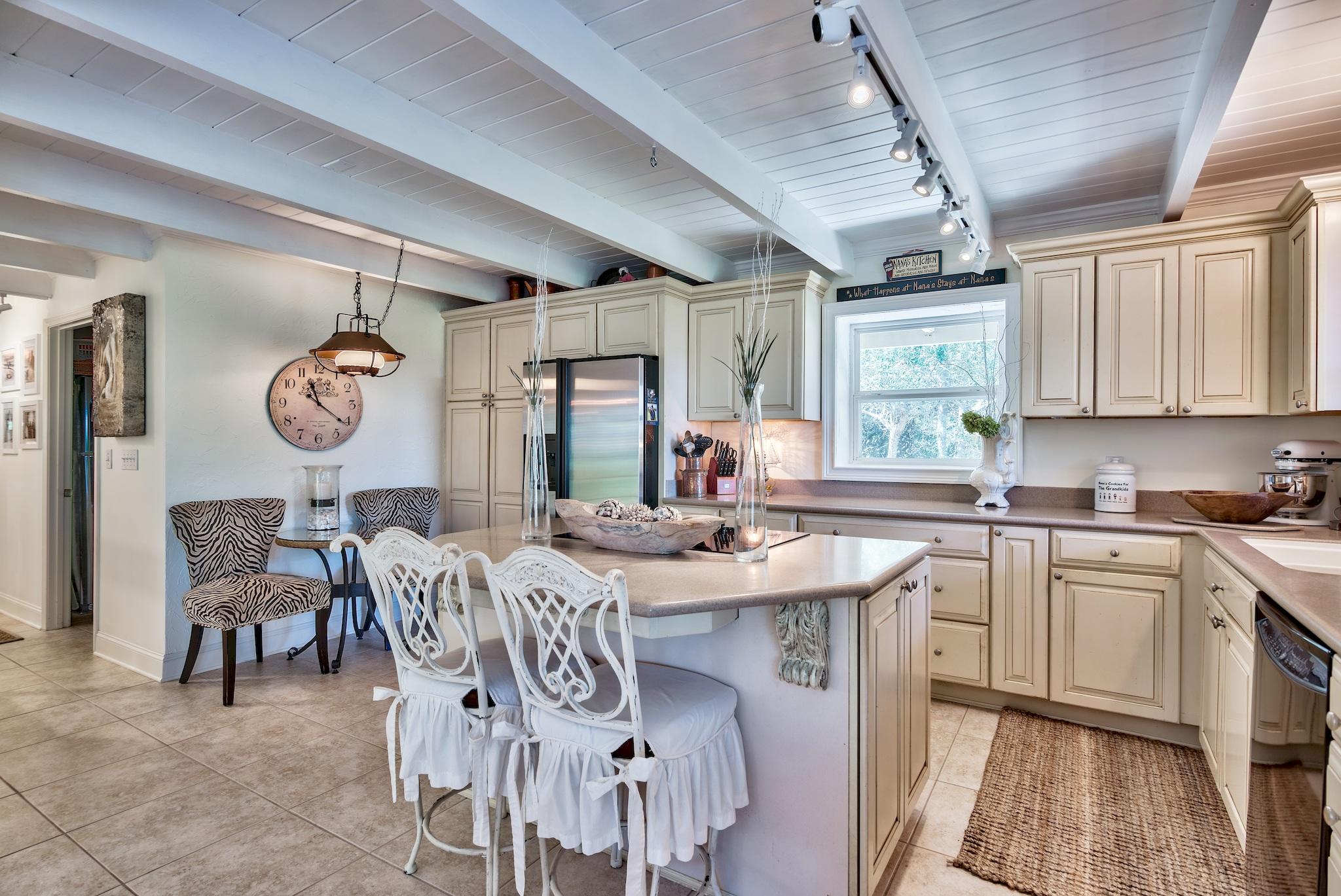 120 South Bishop Road Santa Rosa Beach, FL 32459 - Photo 11 of 64 a view of a kitchen with a table and chairs