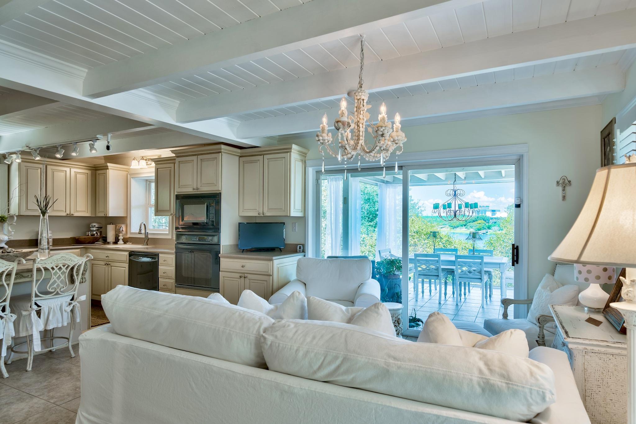 120 South Bishop Road Santa Rosa Beach, FL 32459 - Photo 13 of 64 a living room with furniture and a chandelier