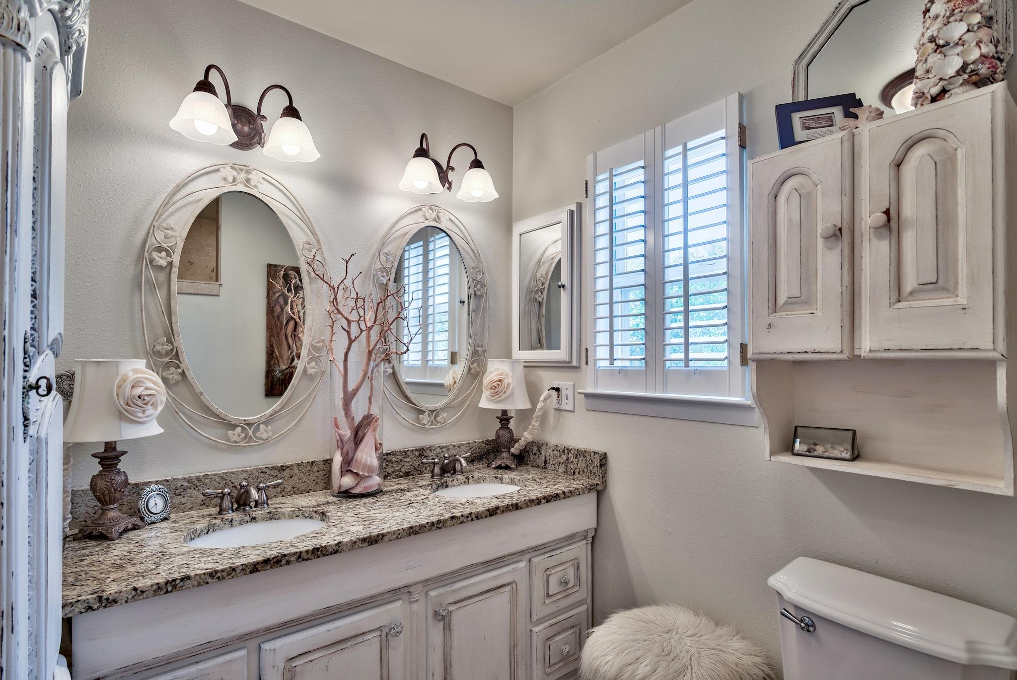 120 South Bishop Road Santa Rosa Beach, FL 32459 - Photo 46 of 64 a bathroom with a granite countertop toilet sink and mirror