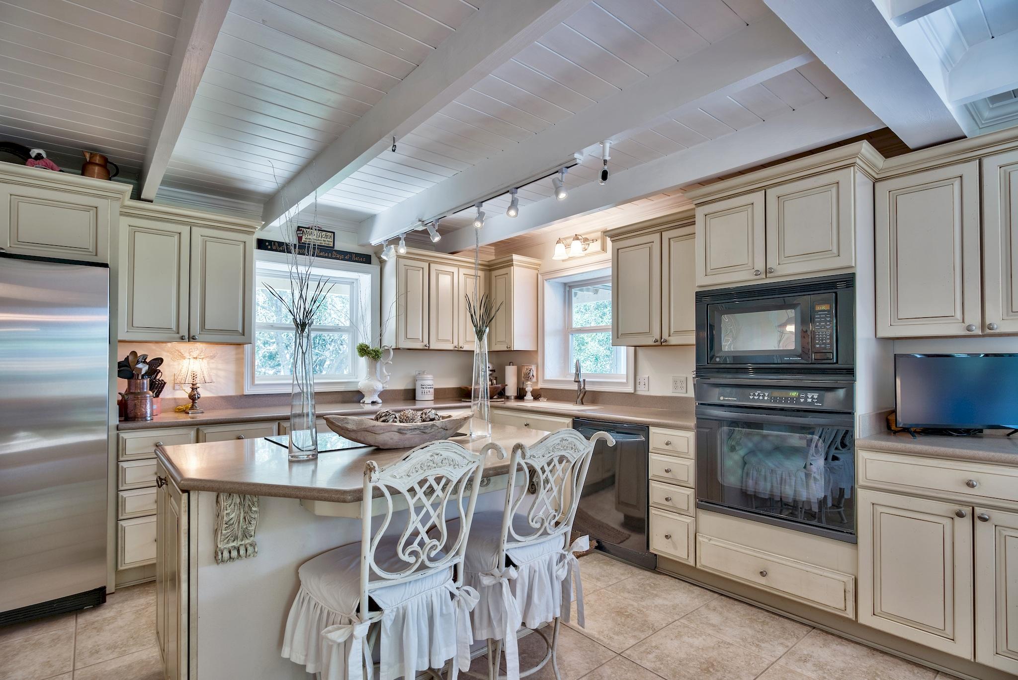 120 South Bishop Road Santa Rosa Beach, FL 32459 - Photo 10 of 64 a kitchen with stainless steel appliances granite countertop a stove a sink a microwave and a refrigerator