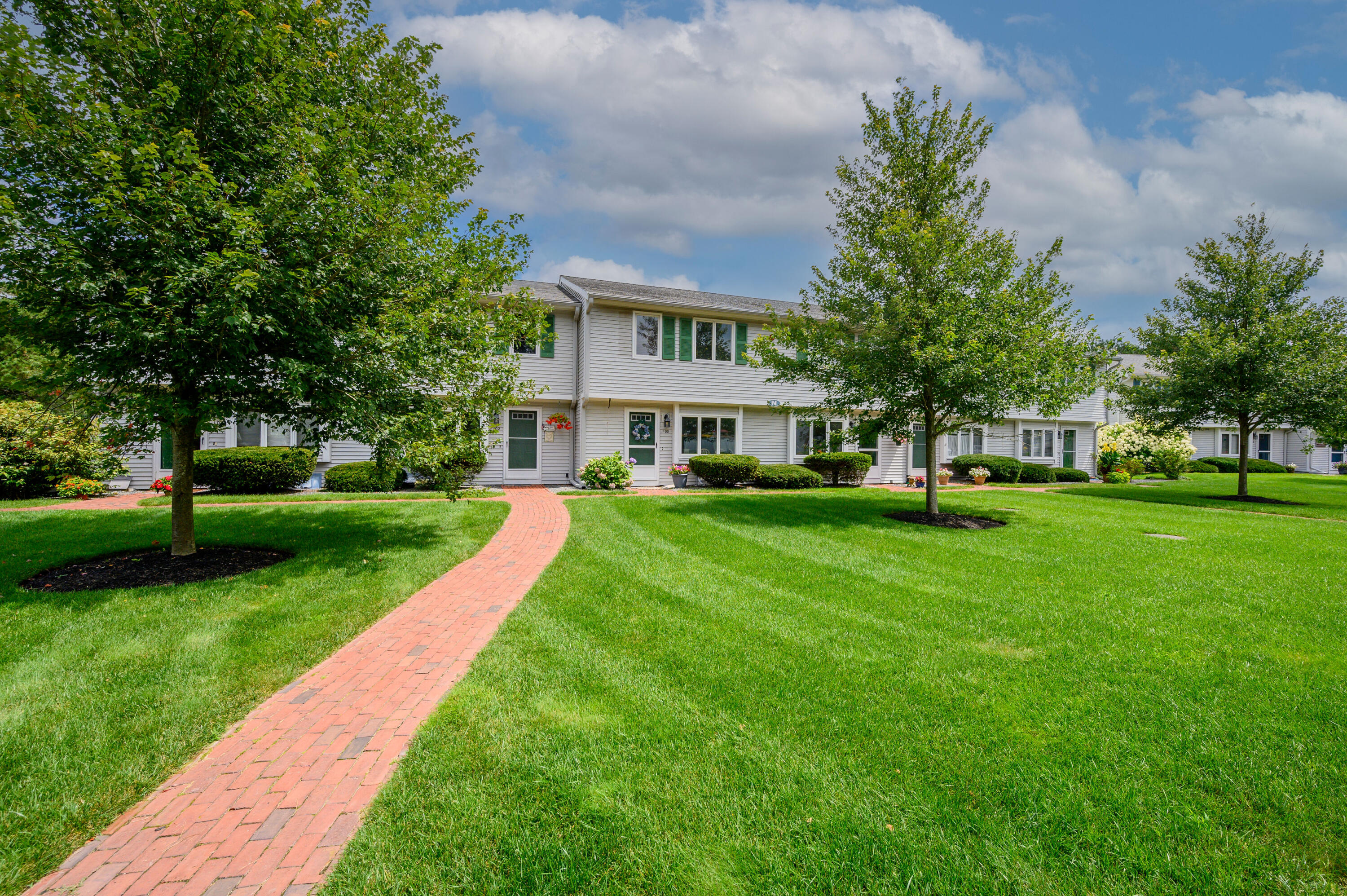 174 Lowell Road, Unit N102 Mashpee, MA 02649 - Photo 35 of 35 a view of an apartment with a garden