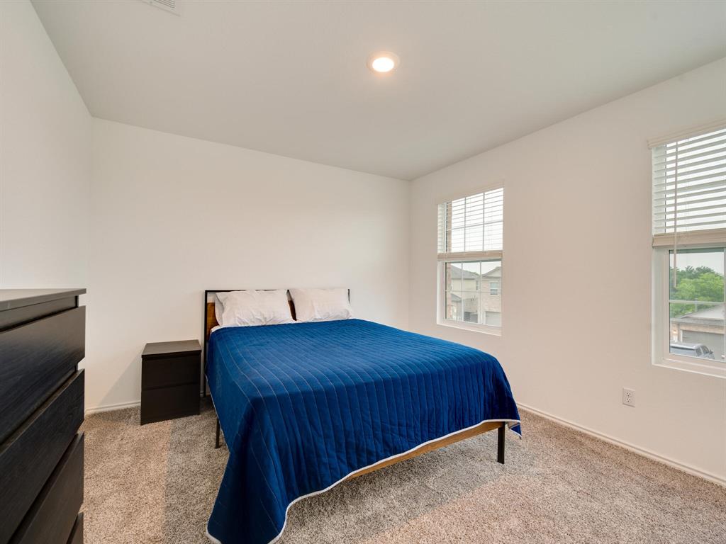 1208 Sweetspire Street Leander, TX 78641 - Photo 24 of 36 Carpeted room featuring dual windows with blinds, recessed ceiling lighting, and neutral wall tones