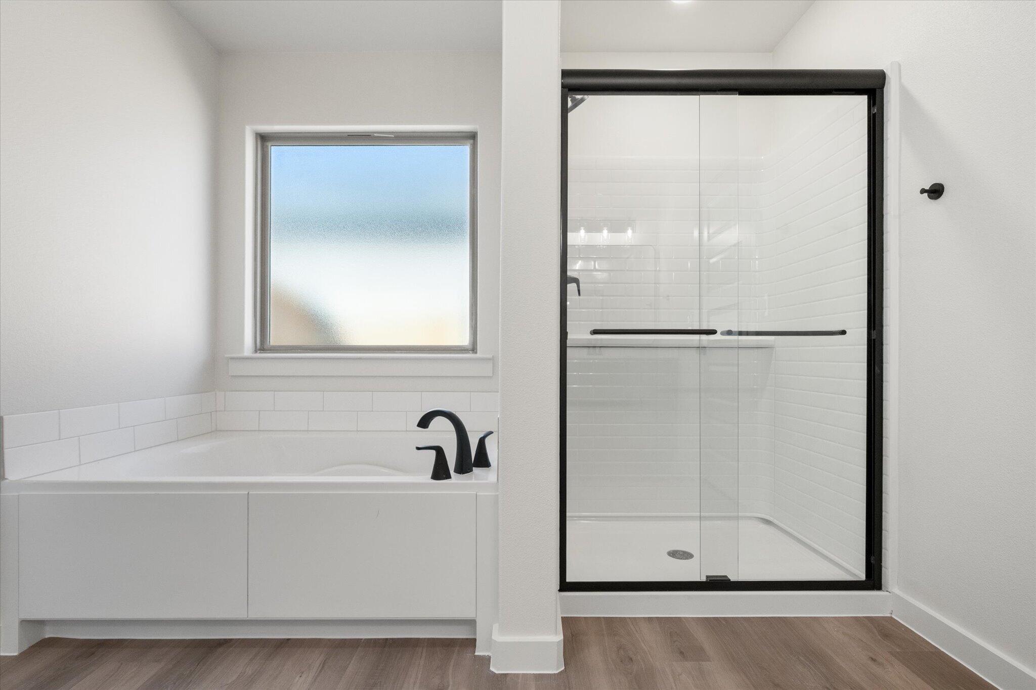 7003 53rd Street Lubbock, TX 79407 - Photo 17 of 25 a white bath tub sitting next to a shower