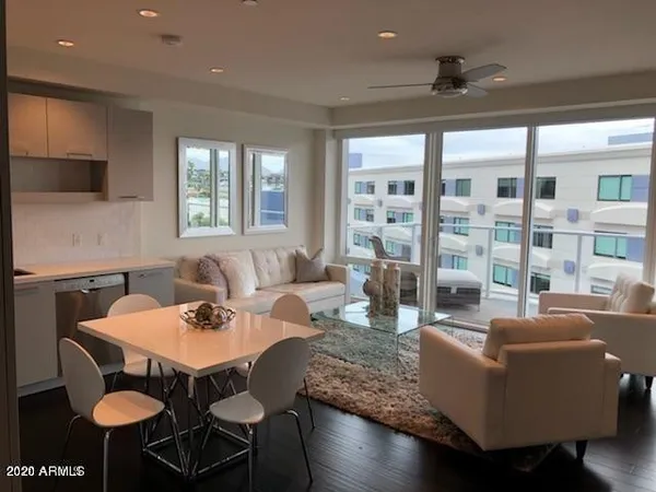a living room with furniture and large windows