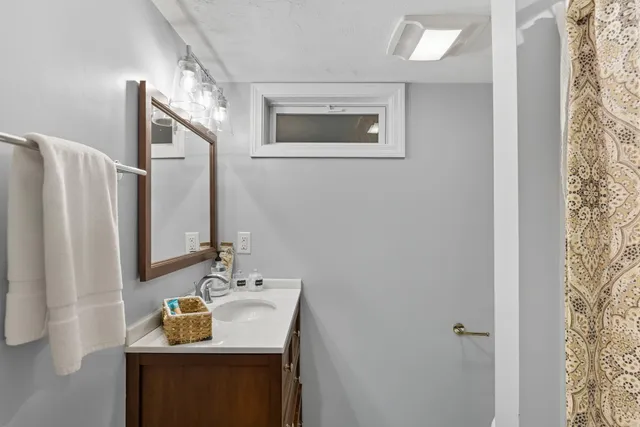 a white house that has a tree in front of it